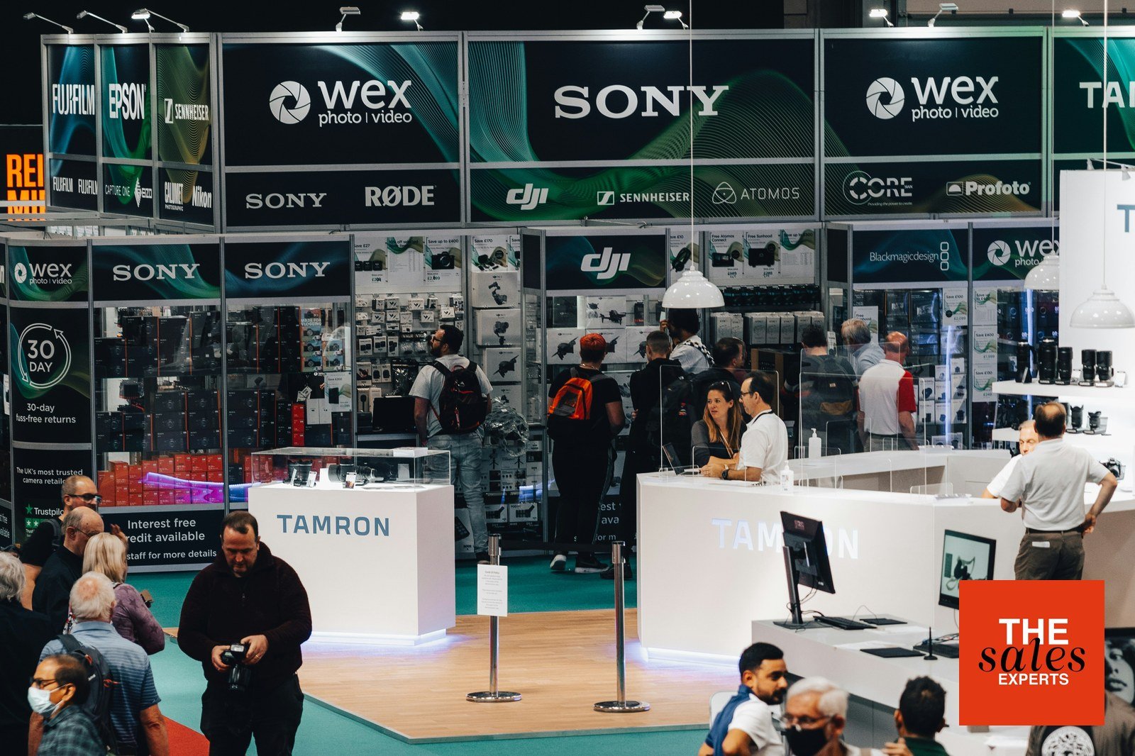 Busy trade show exhibition with sales teams and visitors
