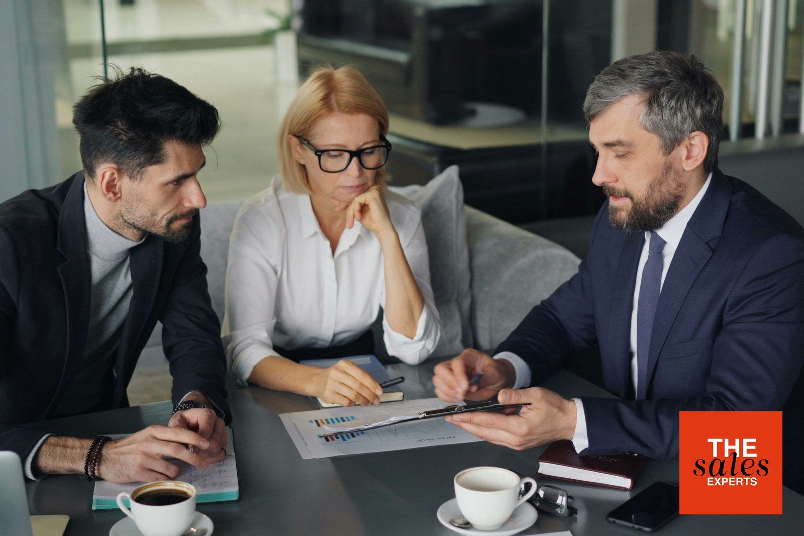 Business leaders reviewing a sales hiring plan